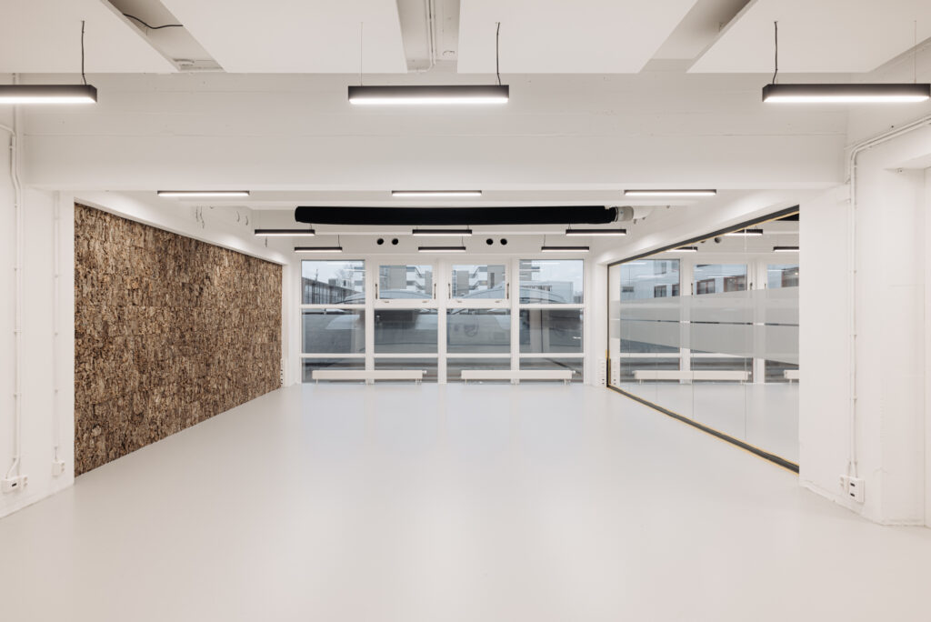 Licht en modern interieur van een lege ruimte aan de Generaal Vetterstraat met grote ramen, glazen wand en kurkwand.